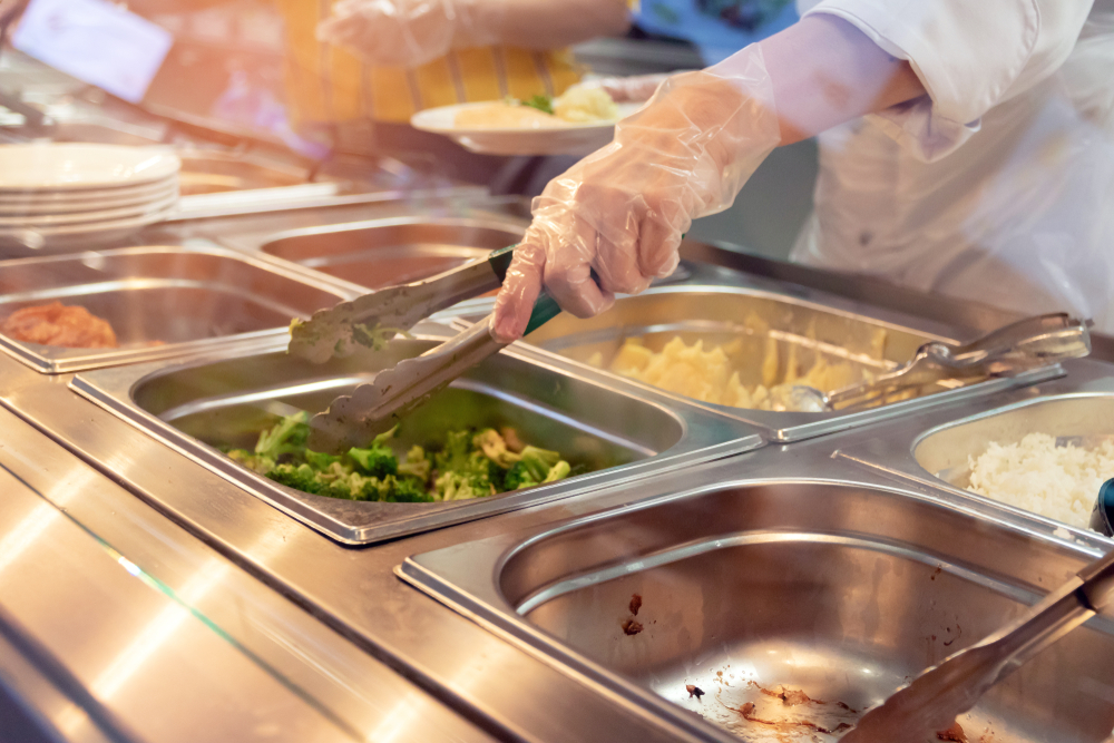 Chef,Standing,Behind,Full,Lunch,Service,Station,With,Assortment,Of